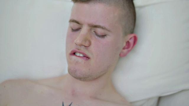 Tattooed twink tugging thick cock while showing body