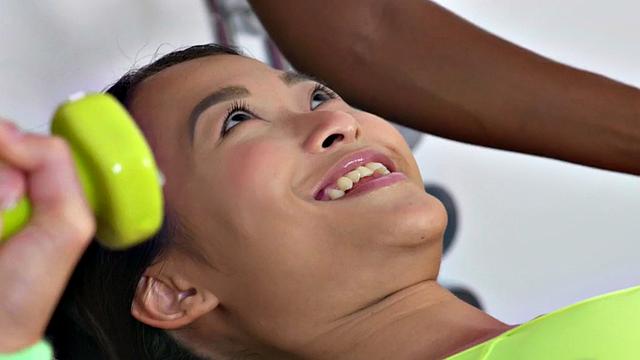 A busty Asian gym babe finger her tight ebony pussy while playing with her ponytail