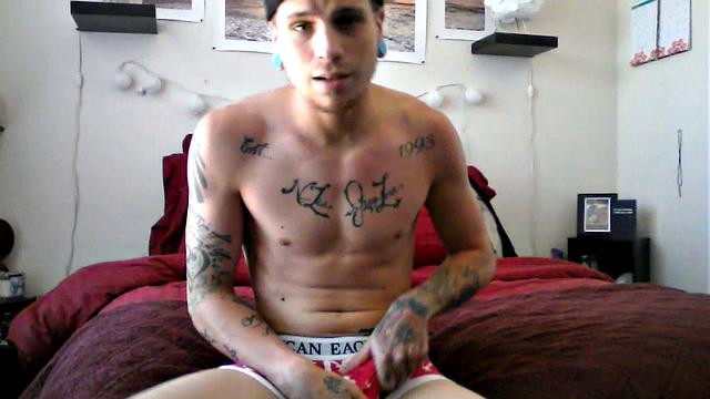 Robbie Callahan is an exhibitionist, and really gets into stroke shows. With all those tattoos, he's definitely got the bad boy look going on and we get to see his body art, as the camera moves in close, while he gets naked.