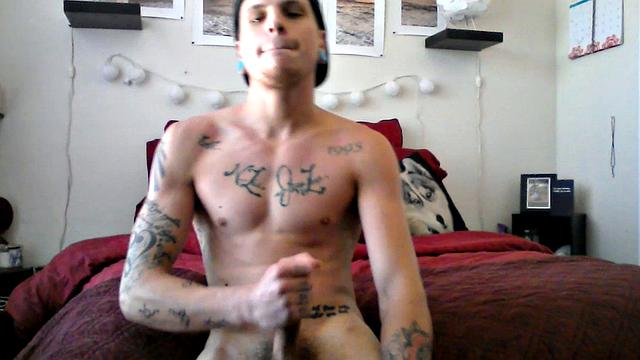 Robbie Callahan is an exhibitionist, and really gets into stroke shows. With all those tattoos, he's definitely got the bad boy look going on and we get to see his body art, as the camera moves in close, while he gets naked.