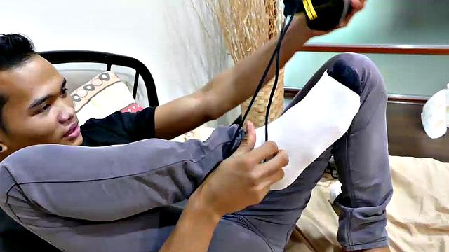 This smooth slim Asian twink loves the smell of his socks and shoes after a long day at work. He's horny for the sweet aroma of his sweaty feet, so he starts his foot fetish solo action.
