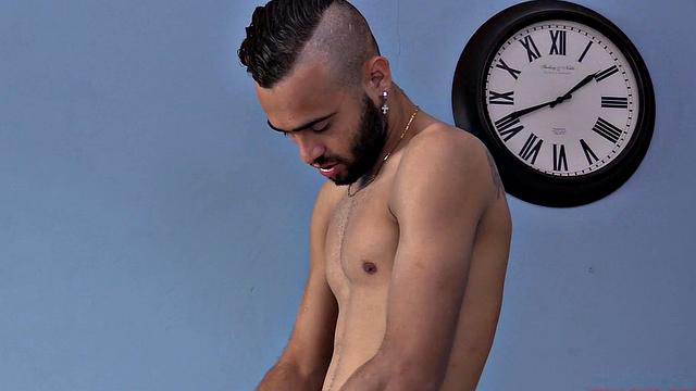 We watch as Ak strips naked and works up a stiff one. Then we are treated to a look at his fine little hairy butt, before the stroke show begins. After beating off, the horny Latino kicks back on a sofa and continues his mission.