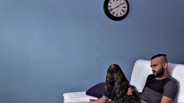 We watch as Ak strips naked and works up a stiff one. Then we are treated to a look at his fine little hairy butt, before the stroke show begins. After beating off, the horny Latino kicks back on a sofa and continues his mission.