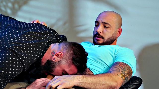 Tattooed stud gets sucked off by bearded top