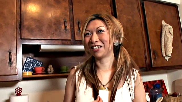 Happily married Taiwanese beauty Veronica diddles her tight cunt in the kitchen with a vibrator