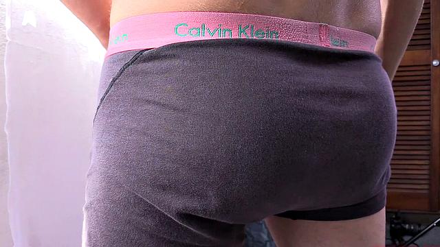 Standing in the natural light of a glass door, Olaf strips naked, working up a big boner. Once naked, he sits on the edge of a bed and starts beating off in earnest.