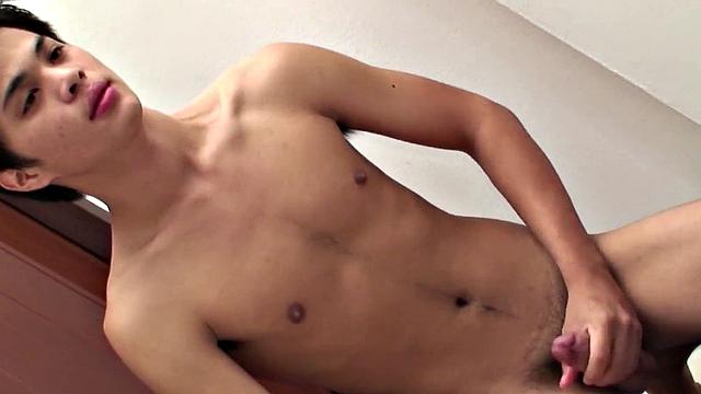 Pissing Asian twink wanks cock in bathroom for cumshot