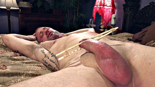 A busty redhead dominate her male submissive in a kinky bondage scene