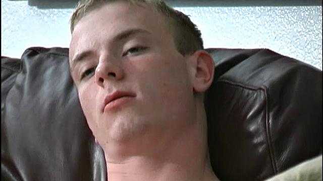 This tall, slender, well-hung young man is friendly, sweet, and a sexual dynamo. The 19-year-old bottom boy is on the sofa watching a porn video, as he peels off his clothes.