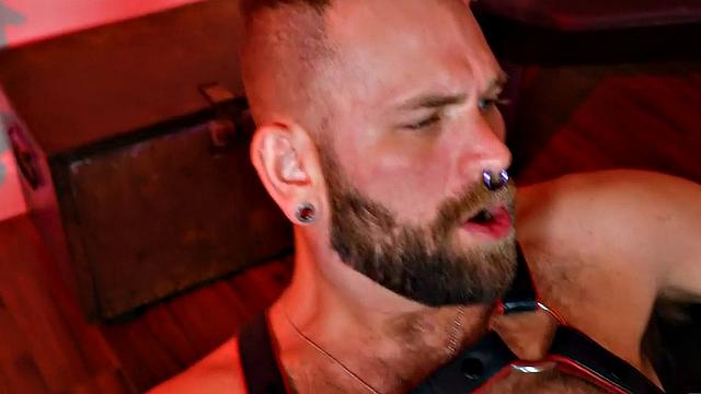 Hairy jock in leather and boots assfisted by BF