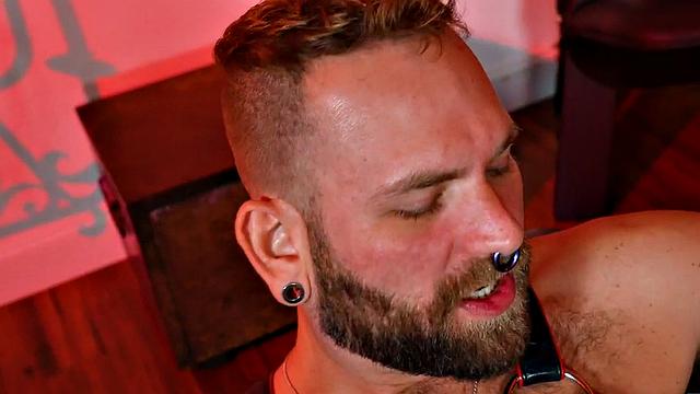 Hairy jock in leather and boots assfisted by BF