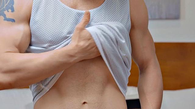 Eager jock with glasses masturbating after exercise