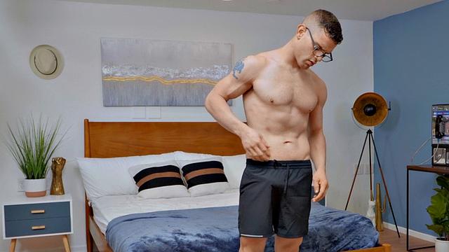 Eager jock with glasses masturbating after exercise