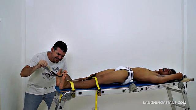 I strapped this cutie down on the rack and had my tickle fetish way with him. His ticklish feet were smooth and silky.