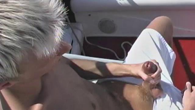 Blond 21 year old Shane Scott is out cruising around in a speedboat when he starts to get horny. He pulls into a secluded cove and strokes his huge cock.