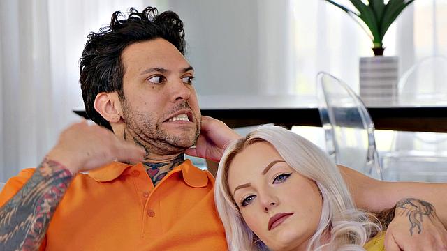 A tattooed brown-haired babe give a sloppy blowjob while wearing shorts and glasses