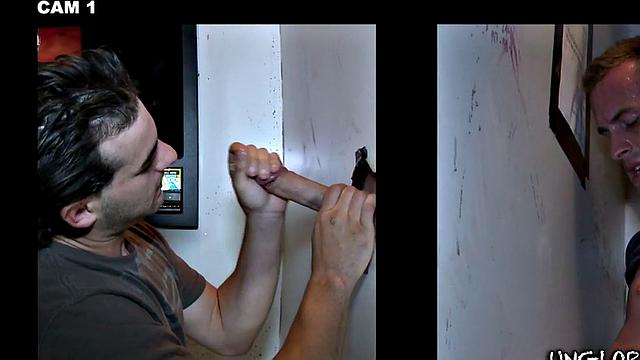 Gay stud sucks and strokes guy's cock in gloryhole