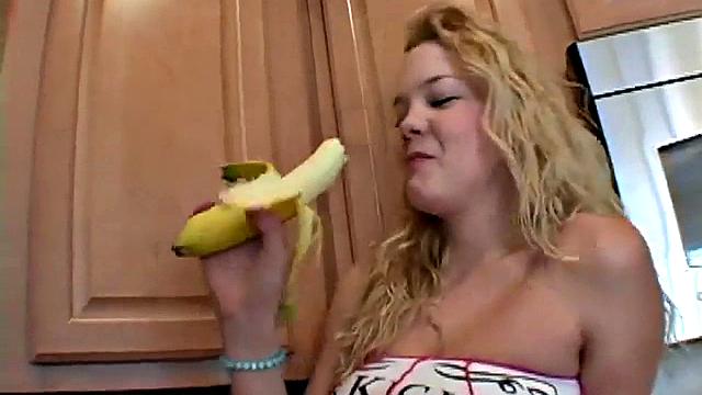 Naughty solo teen chewing on a banana