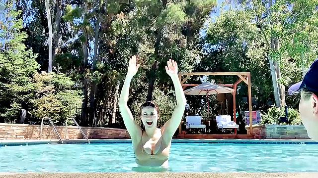 Alexandra Daddario flaunts her bikini body in the pool and shows off her smile