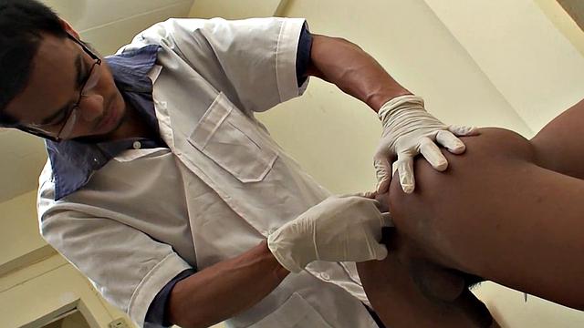 Assfingered Asian twink pissing before by doctor