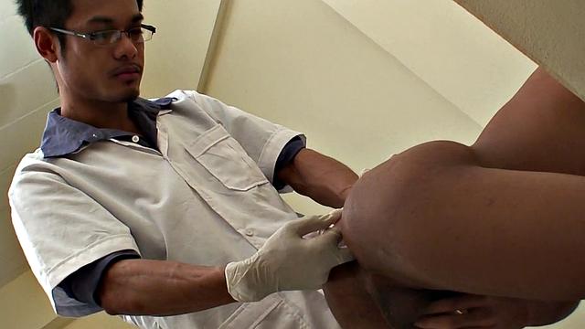 Assfingered Asian twink pissing before by doctor