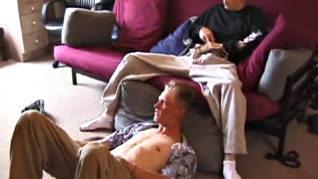 Brandon sits on the floor and rubs the growing bulge in his pants while he watches some bimbos on the TV. Shane comes up the stairs and notices that Brandon is already hard at work and sits down on the couch behind him.