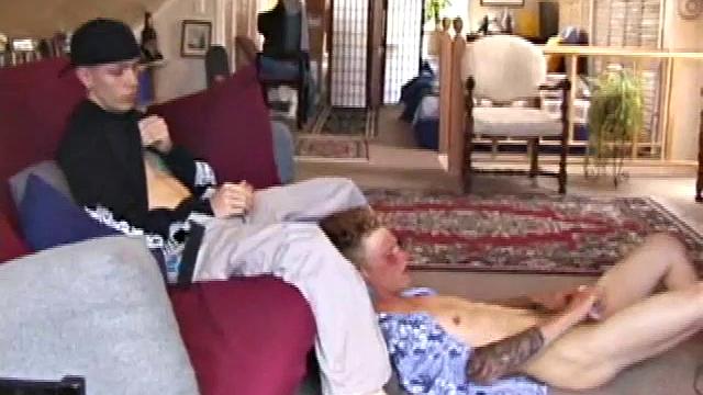 Brandon sits on the floor and rubs the growing bulge in his pants while he watches some bimbos on the TV. Shane comes up the stairs and notices that Brandon is already hard at work and sits down on the couch behind him.