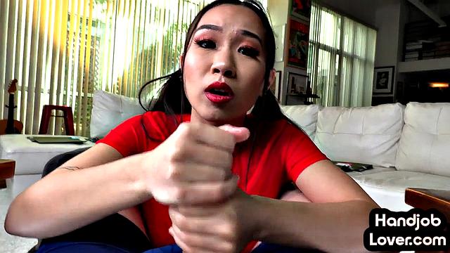 Horny asian babe wanking lover's dick