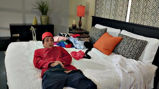 Watch this tattooed MILF in fishnets ride and finger her trimmed pussy in bed