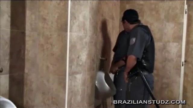 After buying sex toys, Hernan goes in the restroom to check them out. Cristo walks in wearing his cop uniform to take a piss and fellow cop Miguel comes in behind him.