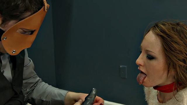 Rope-bound slut gagging on toy