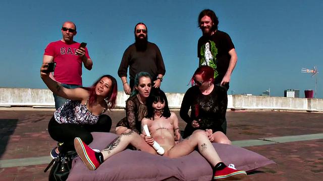 BDSM teen enjoys outdoor body torment from group
