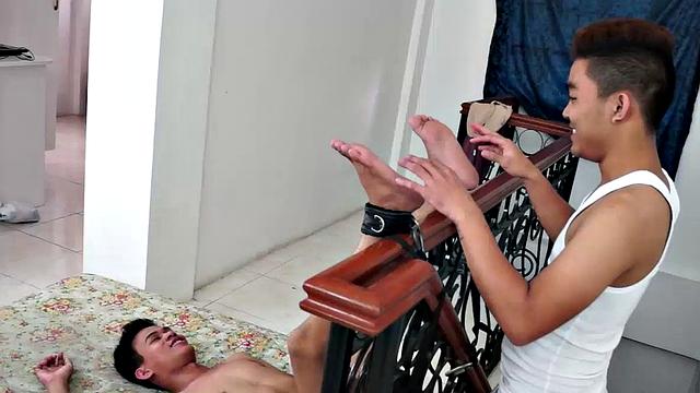 Yes, another rousing foot tickle time with twinks! Warren's ankles are strapped soles up for full tickling access to his Asian boy feet.