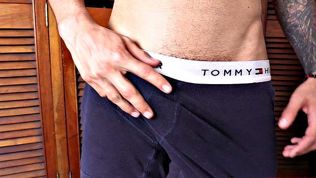 We find Dante stripped to his underwear and already sporting a big boner. He pulls that big cock out and plays, before getting totally naked. A long stroke follows, as this slim and smooth young man jerks off all over the room.