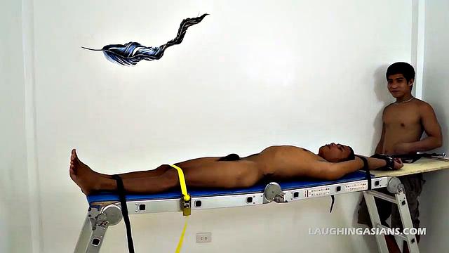 Asian twink Javey gets bound to the tickling rack for a tickle fetish video. Jesse is the first tickle master who feathers his bare feet, making the ticklish Asian boy squirm.