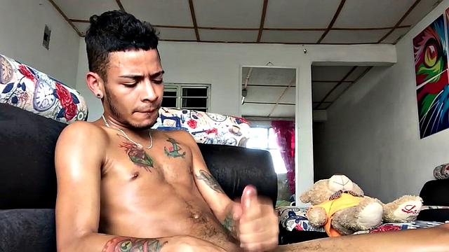 Skinny inked Latino strips and masturbates in solo