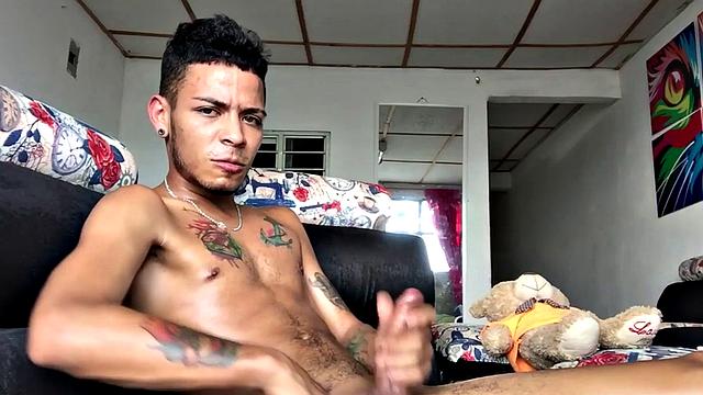 Skinny inked Latino strips and masturbates in solo