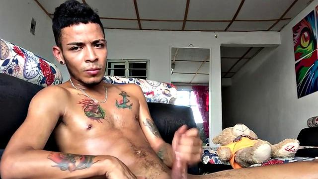 Skinny inked Latino strips and masturbates in solo