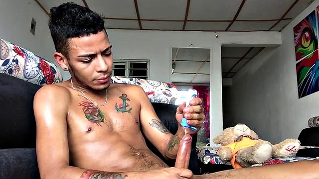 Skinny inked Latino strips and masturbates in solo