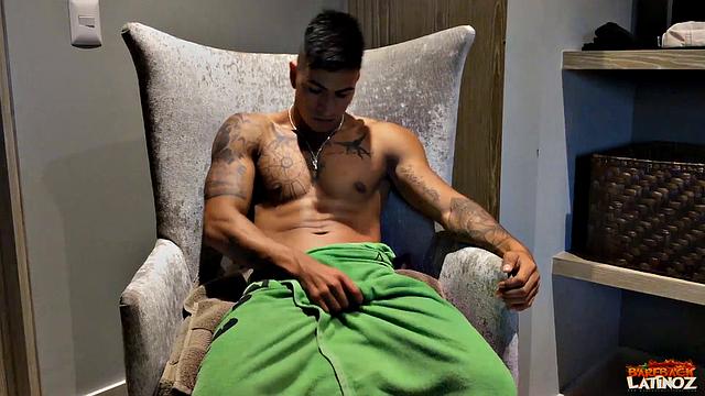 Our featured solo boy of the week is inked and muscular Erick. Wrapped in a towel, the young Latino parks his ass in a chair and teases us before getting naked.