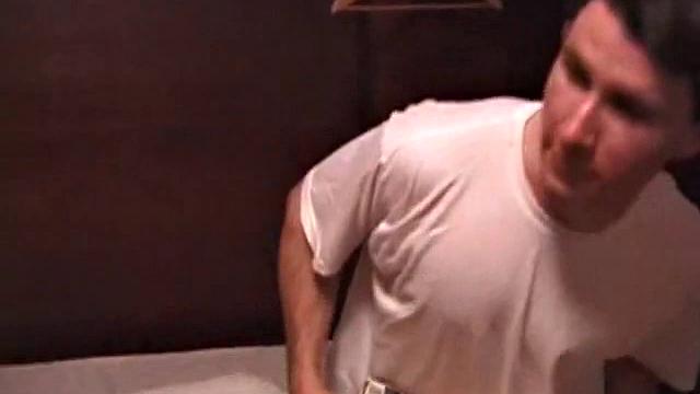 Adam relaxes on the floor watching porn video, strokes cock, plays with butthole, and blasts cum load onto skateboard