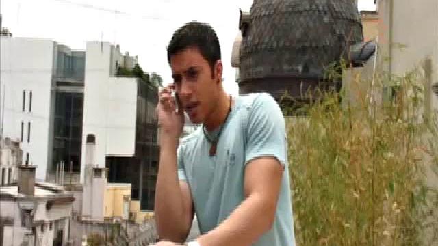 Niko Tomiar and Oscar Blanco are relaxing on the couch. Niko is with curly black hair and big white smile. Oscar knows it, too. He starts rubbing all over Niko as the two kiss.