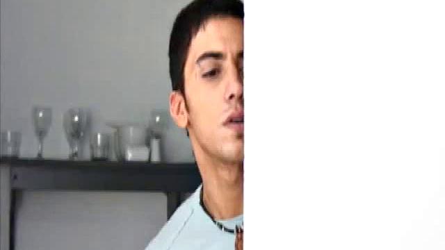 Niko Tomiar and Oscar Blanco are relaxing on the couch. Niko is with curly black hair and big white smile. Oscar knows it, too. He starts rubbing all over Niko as the two kiss.