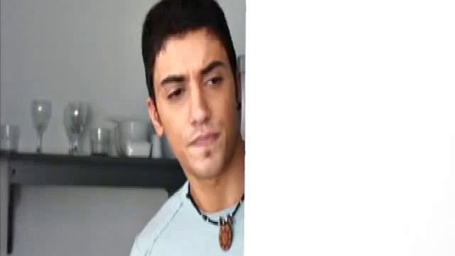 Niko Tomiar and Oscar Blanco are relaxing on the couch. Niko is with curly black hair and big white smile. Oscar knows it, too. He starts rubbing all over Niko as the two kiss.