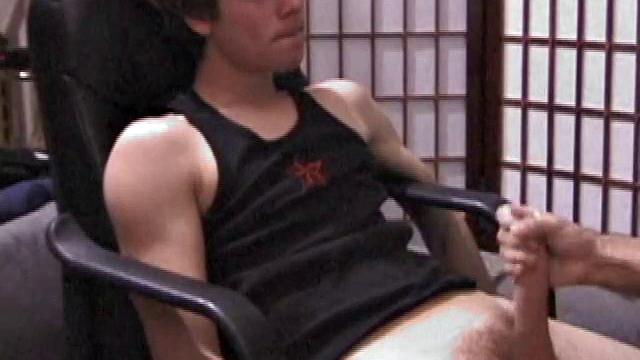 Kicking back in a chair, Jayden is ready to jack off again, and we get to watch! This time he enjoys some help from a mystery hand that edges out his cum.