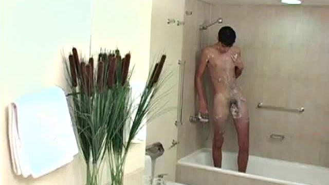 Felipe's huge, uncut cock dangles between his legs as he showers, dries off and strokes his meat to full erection on the counter top, next to the mirror.