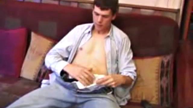 After hanging out with friends for the afternoon, Matthew finds himself on the couch with a raging boner and no one to help. So, he throws in a porn, sticks a hand down his pants and starts playing with himself.