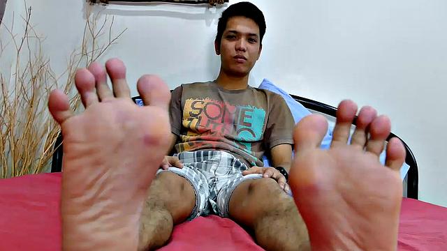This Asian boy has a huge cock. And he loves to jerk off while playing with his feet. This Asian gay boy starts off by showing his slim sexy feet to the camera up close. Enjoy his wiggling toes as he takes his big dick in hand and starts stroking.