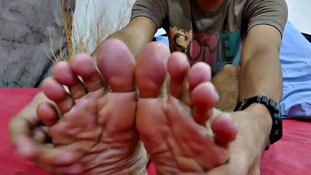 This Asian boy has a huge cock. And he loves to jerk off while playing with his feet. This Asian gay boy starts off by showing his slim sexy feet to the camera up close. Enjoy his wiggling toes as he takes his big dick in hand and starts stroking.