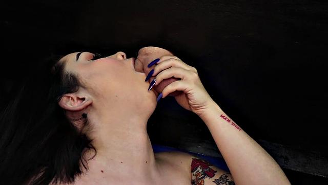 Watch this tattooed brunette babe stroke herself with a Hitachi while pleasuring herself in the glory hole